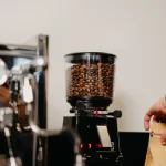 Home coffee grinder filled with coffee beans